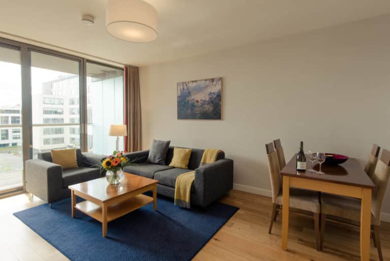 PREMIER SUITES Dublin Sandyford bright lounge with coffee table, sofa and dining table