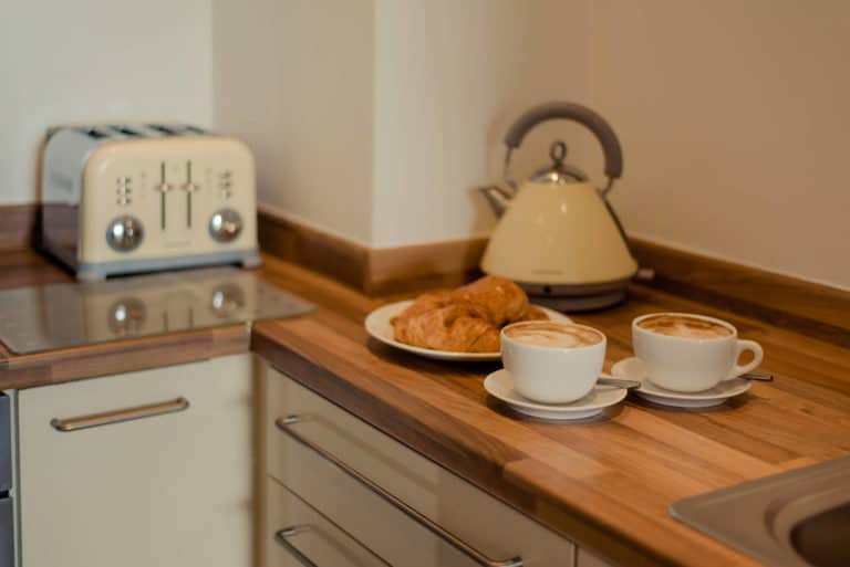 PREMIER SUITES Dublin Sandyford preparing coffee and breakfast in fully equipped kitchen